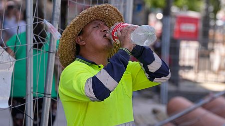 A road worker stops to take a drink of water in Madrid, Spain.