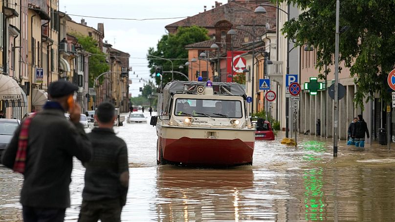 Firefighters arrive in the flooded village of Castel Bolognese, Italy, 17 March 2023.