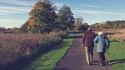 Older couple walking.