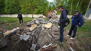 People look at fragments of the television tower which was broken in half after it was hit by a Russian missile in Kharkiv, Ukraine, Monday, April 22, 2024. 