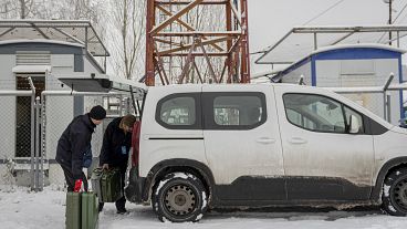Technicians of Ukrainian mobile telephone network operator Kyivstar, deliver jerrycans with fuel to a phone tower on the outskirts of Kyiv, Ukraine, 2022.