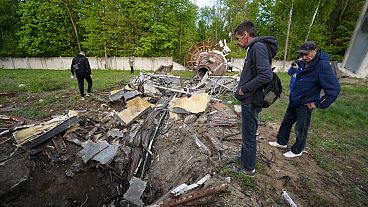 People look at fragments of the television tower which was broken in half after it was hit by a Russian missile in Kharkiv, Ukraine, Monday, April 22, 2024. 