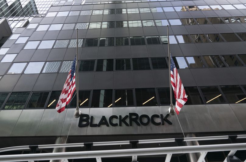 Flags fly on the front of BlackRock headquarters in New York, January 2021