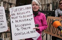 Trudi Warner was accused of contempt for holding a sign reminding jurors of their right to acquit based on conscience.