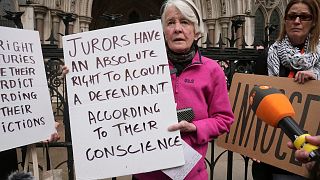 Trudi Warner was accused of contempt for holding a sign reminding jurors of their right to acquit based on conscience.