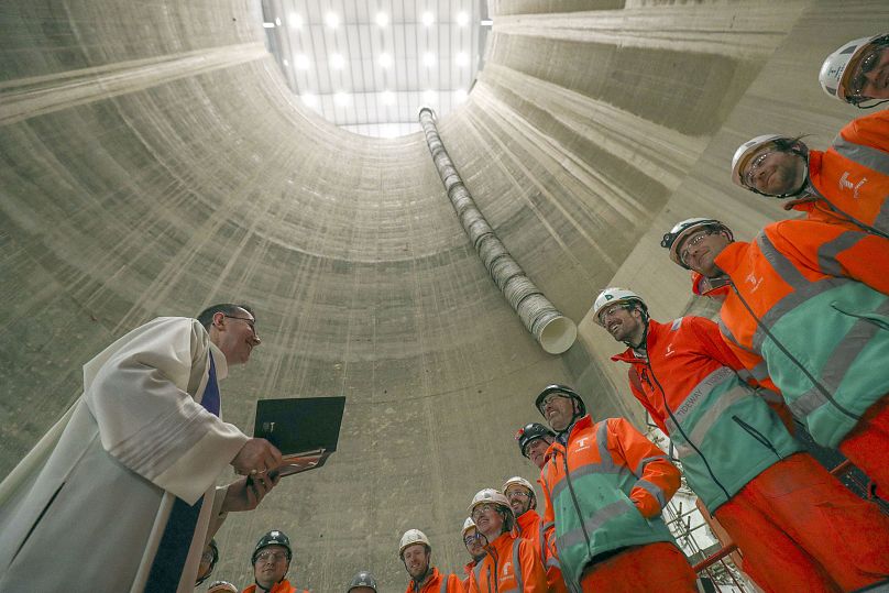 The Canon Pastor of Southwark Cathedral blesses the statue of Santa Barbara (patron saint of tunnellers) and workers during a service at the Thames Tideway Tunnel, 2020.