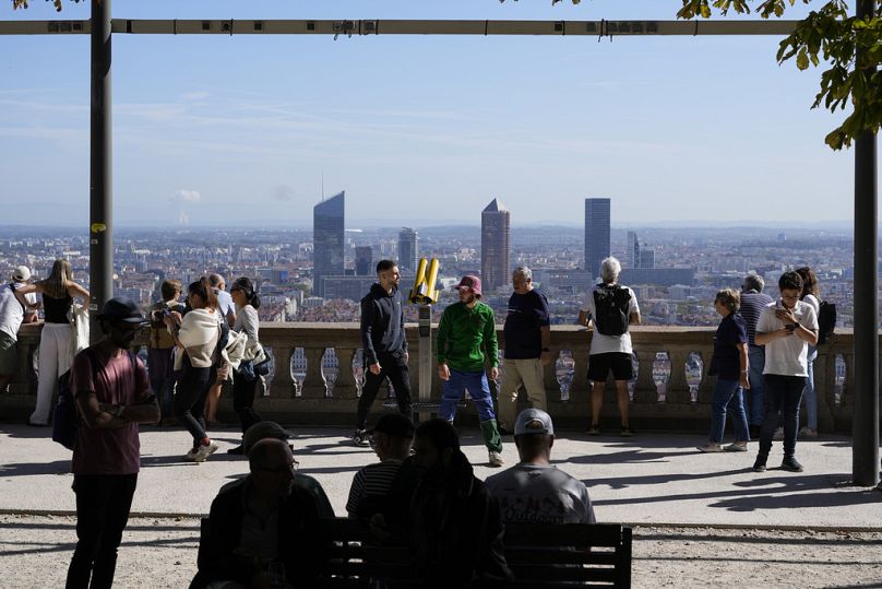 People enjoy a viewpoint in Lyon, October 2023