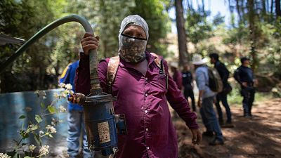 A man shows a pump removed from an unlicensed water intake in the mountains of Villa Madero, Mexico, 17 April 2024. 
