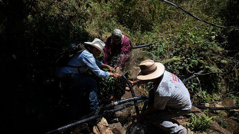 People dismantle an unlicensed water intake as their group of residents, farmworkers and small-scale farmers disconnect water taps in the mountains of Villa Madero.