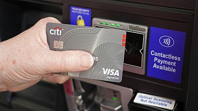 A customer uses the contactless payment chip in their Visa card to purchase gasoline at a station in Ridgeland, Miss., Thursday, July 1, 2021. 