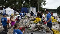 Volunteers in Hungary clear waste plastic from a river.