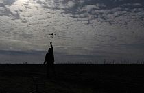 A Ukrainian serviceman from Code 9.2 unit known by call sign Mamay catches a drone at the frontline, few kilometres from Bakhmut, Donetsk region, Ukraine, 24/04/24.