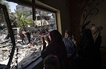 Members of the Abu Draz family inspect their house after it was hit by an Israeli airstrike in Rafah, southern Gaza