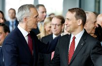 NATO Secretary General Jens Stoltenberg, left, shakes hands with Poland's Foreign Minister Radoslaw Sikorski, April 4, 2024. 