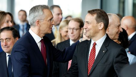 NATO Secretary General Jens Stoltenberg, left, shakes hands with Poland's Foreign Minister Radoslaw Sikorski, April 4, 2024. 