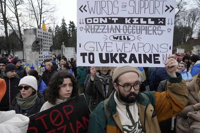 Ukrainians and Poles assemble to protest the invasion of Ukraine in front of the Russian Embassy in Warsaw.