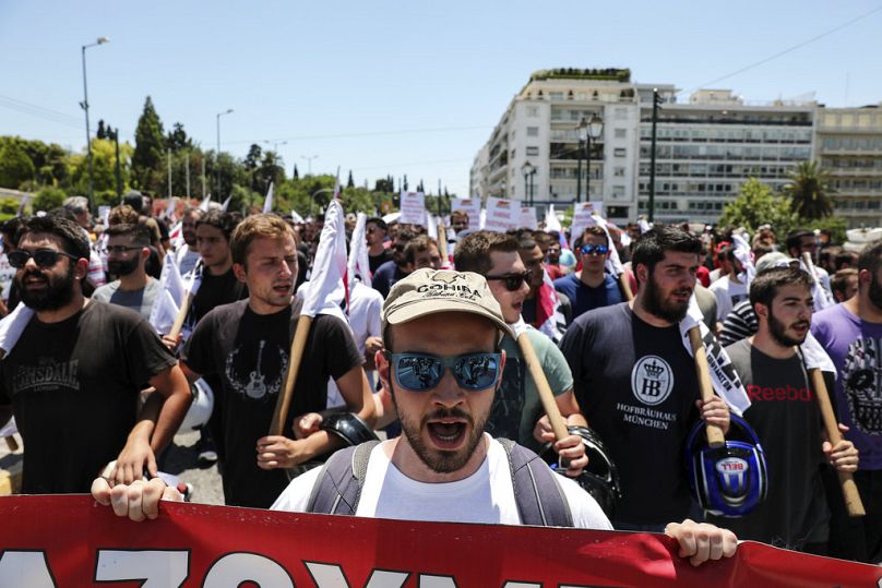 Protesters chant slogans during an anti-austerity rally in Athens, June 2018