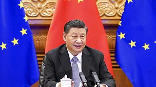 In this photo released by Xinhua News Agency, Chinese President Xi Jinping speaks during a video conference with European leaders from Beijing on Wednesday, Dec. 30, 2020. 