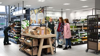 An employee and customers at Sweden's alcohol retail monopoly, Systembolaget