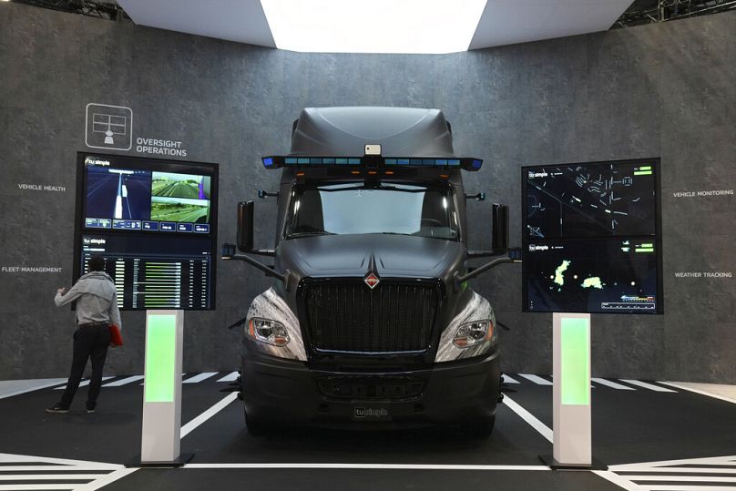 A person looks at autonomous driving technology on a truck on display during the CES tech show in Las Vegas, January 2022