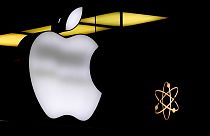The Apple logo is illuminated at a store in Munich, Germany, Nov. 13, 2023.