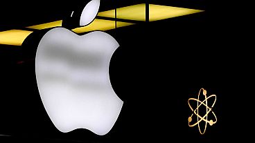 The Apple logo is illuminated at a store in Munich, Germany, Nov. 13, 2023.