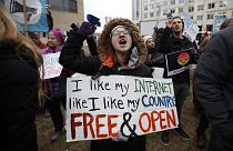 Lindsay Chestnut of Baltimore holds a sign that reads "I like My Internet Like I Like my Country: Free & Open".