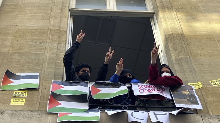 Students blocking the Sciences-Po university flash the V sign Friday, April 26, 2024 in Paris. Students at a prestigious university resumed pro-Palestinian protests on Friday.