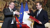 French Defense Minister Sebastien Lecornu, right, and his German counterpart Boris Pistorius shake hands after signing an agreement in Paris on Friday, April 26, 2024. 