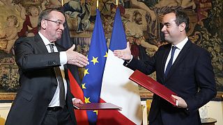 Ο Γάλλος υπουργός Άμυνας Σεμπαστιέν Λεκόρνου, δεξιά, και ο Γερμανός ομόλογός του Μπόρις Πιστόριους σφίγγουν τα χέρια μετά την υπογραφή συμφωνίας στο Παρίσι την Παρασκευή 26 Απριλίου 2024. 