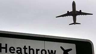 Trouble ahead? A plane takes off over a road sign near Heathrow Airport 