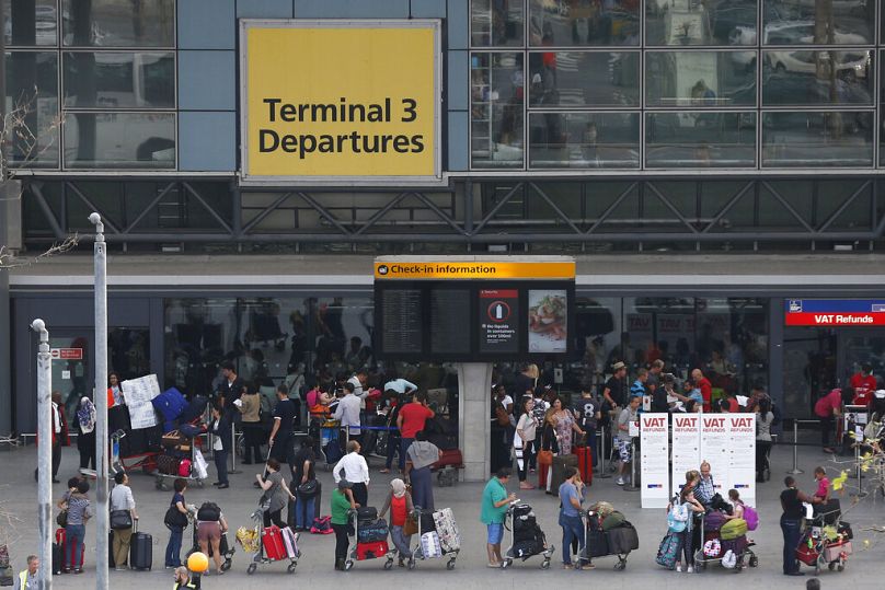 Passengers queue outside Terminal 3 at Heathrow Airport in this file photo