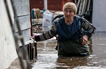 A woman walks near her house in a flooded area in Orenburg, Russia, 10 April, 2024.