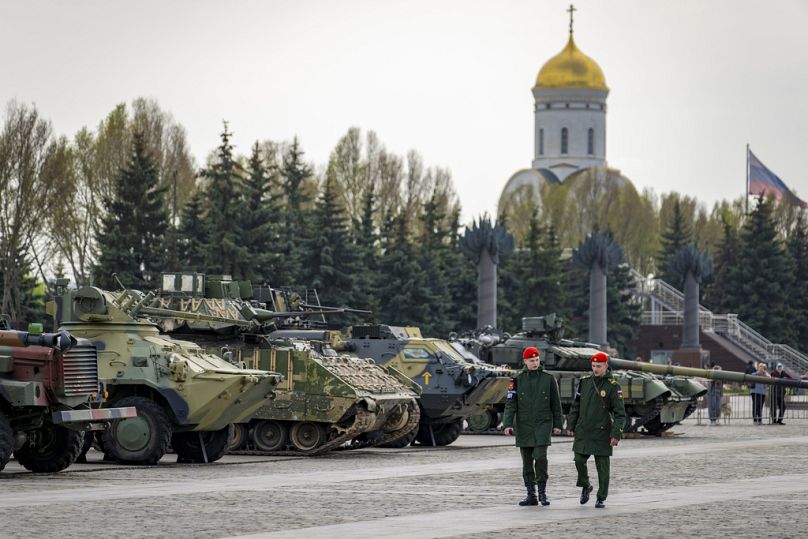 Military policemen guard an exhibition of tanks, APCs and guns of Ukrainian armed forces captured during the fighting displayed near the World War II museum on Poklonnaya Hill