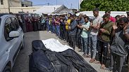 Mourners pray over the bodies of Palestinians who were killed in an Israeli airstrike in Nuseirat, at the Al Aqsa hospital in  Gaza Strip, Saturday, April 27, 2024