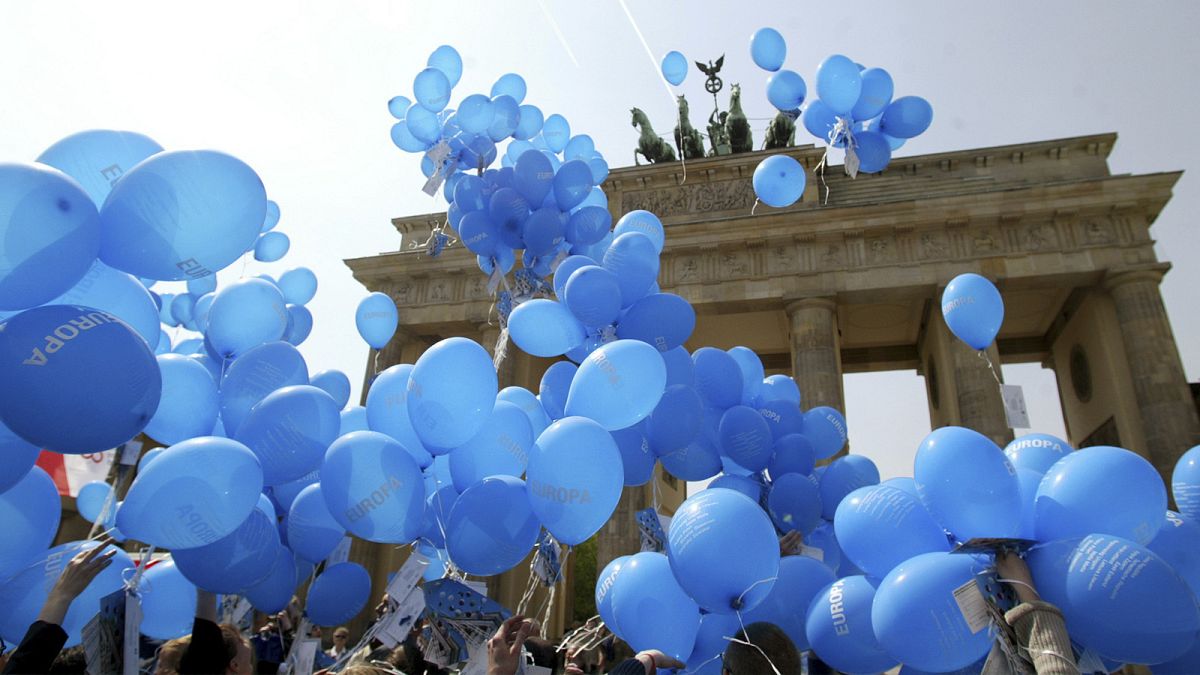 Blue balloons with the slogan "Europa (Europe)" fly during an EU event in front of the Brandenburg Gate in Berlin, one day before the enlargement of the EU, 30 April 2004