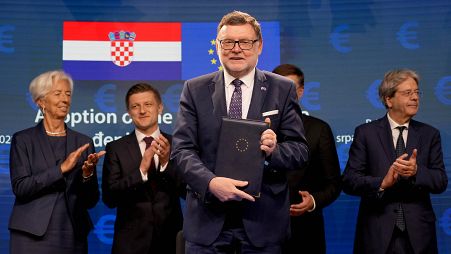 Croatia's Finance Minister Zdravko Maric joins other EU dignitaries at a signing ceremony for Croatia to join the euro in Brussels, Tuesday, July 12, 2022.