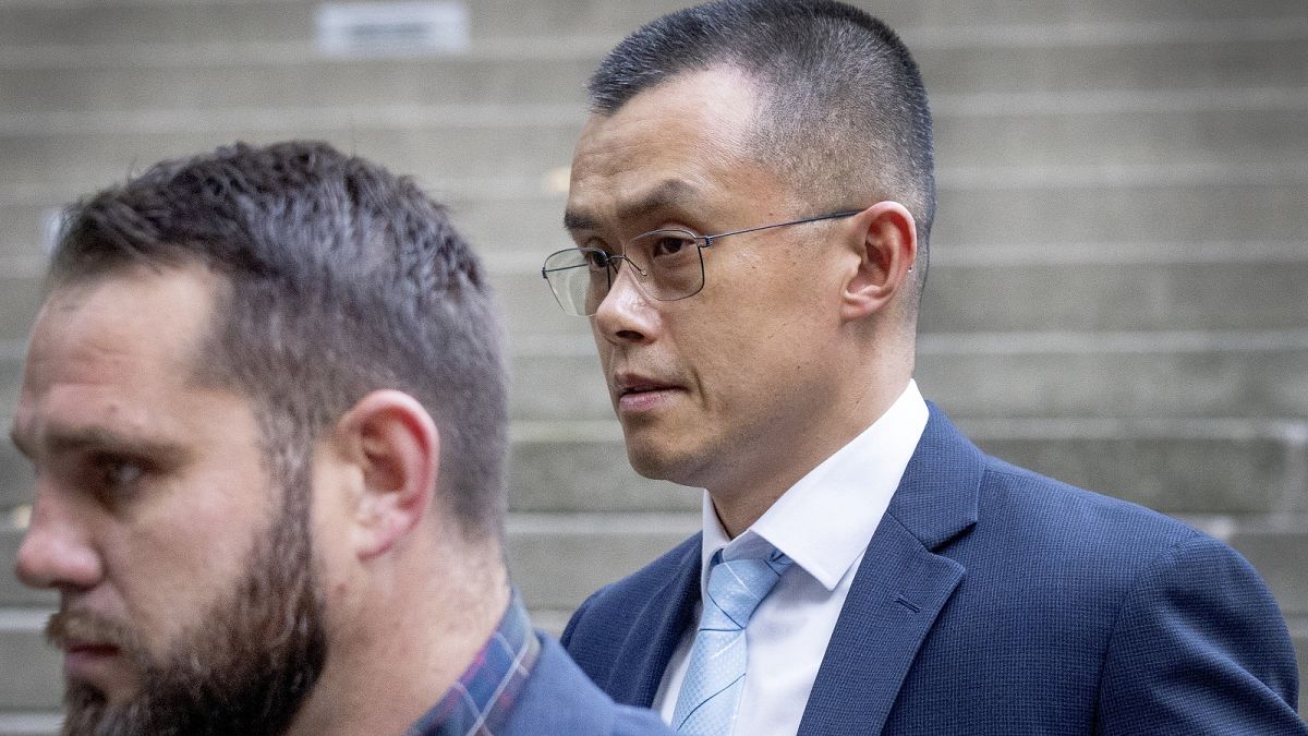 Binance founder and CEO Changpeng Zhao, right, leaves federal court in Seattle on November 21, 2023.