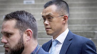 Binance founder and CEO Changpeng Zhao, right, leaves federal court in Seattle on November 21, 2023.