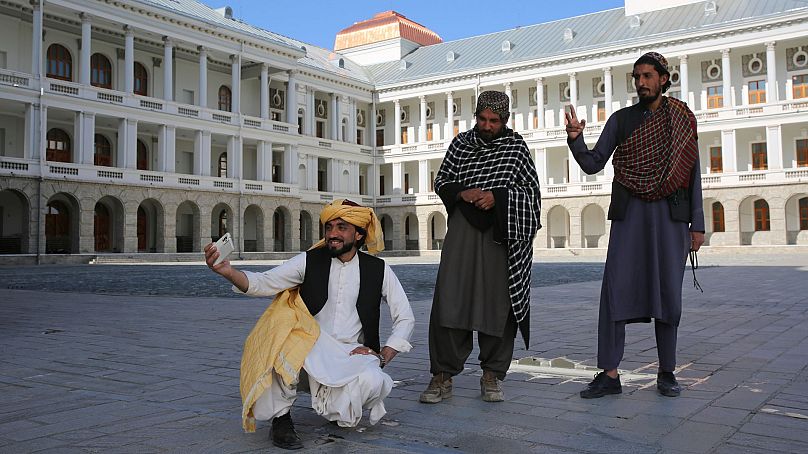 Afghans take selfies at the renovated Darul Aman Palace in Kabul, Afghanistan, 24 April 2024.