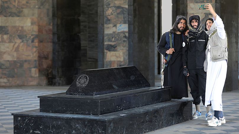 Taliban fighters take selfies by the tomb of Afghan Kind Nadir Shah in Kabul, Afghanistan, 24 April 2024.