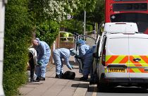 Forensic investigators in Hainault, north east London, where a man wielding a sword attacked members of the public and police officers.