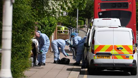 Forensic investigators in Hainault, north east London, where a man wielding a sword attacked members of the public and police officers.