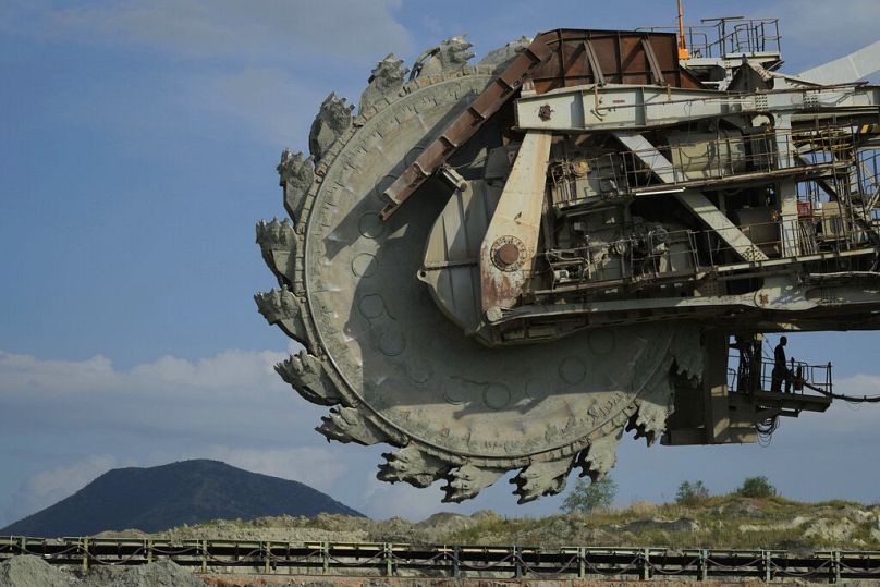 A worker stands at a coal excavator at Greece's largest mine outside the northern city of Kozani, June 2022