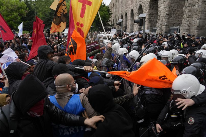 Union members clash with Turkish anti riot police officers as they march during Labor Day celebrations in Istanbul, Turkey, Wednesday, May 1, 2024.