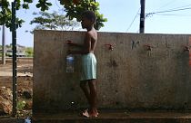 A boy fills up a bottle at the water fountain in M'tsamoudou, near Bandrele on the French Indian Ocean territory of Mayotte.