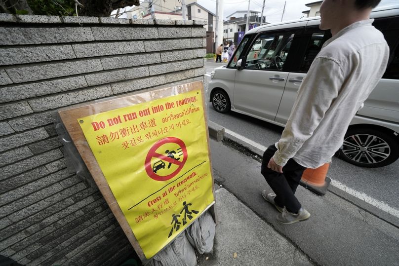 A much ignored notice for tourists across the use road from the Lawson convenience store, where a popular photo spot framing a picturesque view of Mount Fuji in the background