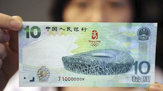Kínai nő egy 10 jüanos bankjeggyel