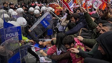 Union members clash with Turkish anti riot police officers as they march during Labor Day celebrations in Istanbul, Turkey, Wednesday, May 1, 2024. 