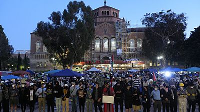 Pro-Palestinian demonstrators lock arms on the UCLA campus Wednesday, May 1, 2024, in Los Angeles.